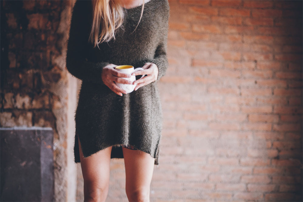Girl-in-Sweatshirt-having-Cup-of-Tea