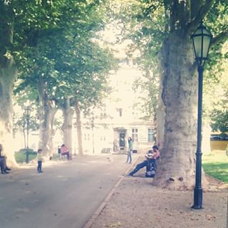 boy sitting on bench in park