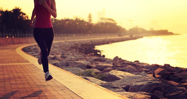 female jogger running along the coast