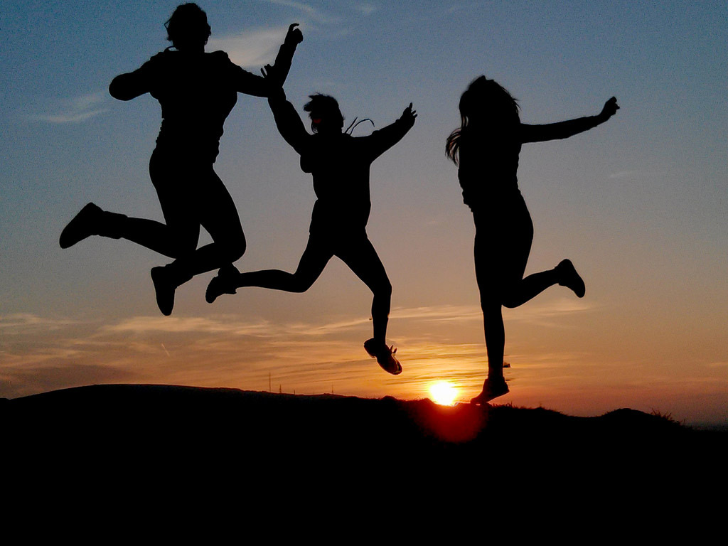 students jumping for joy silhouette