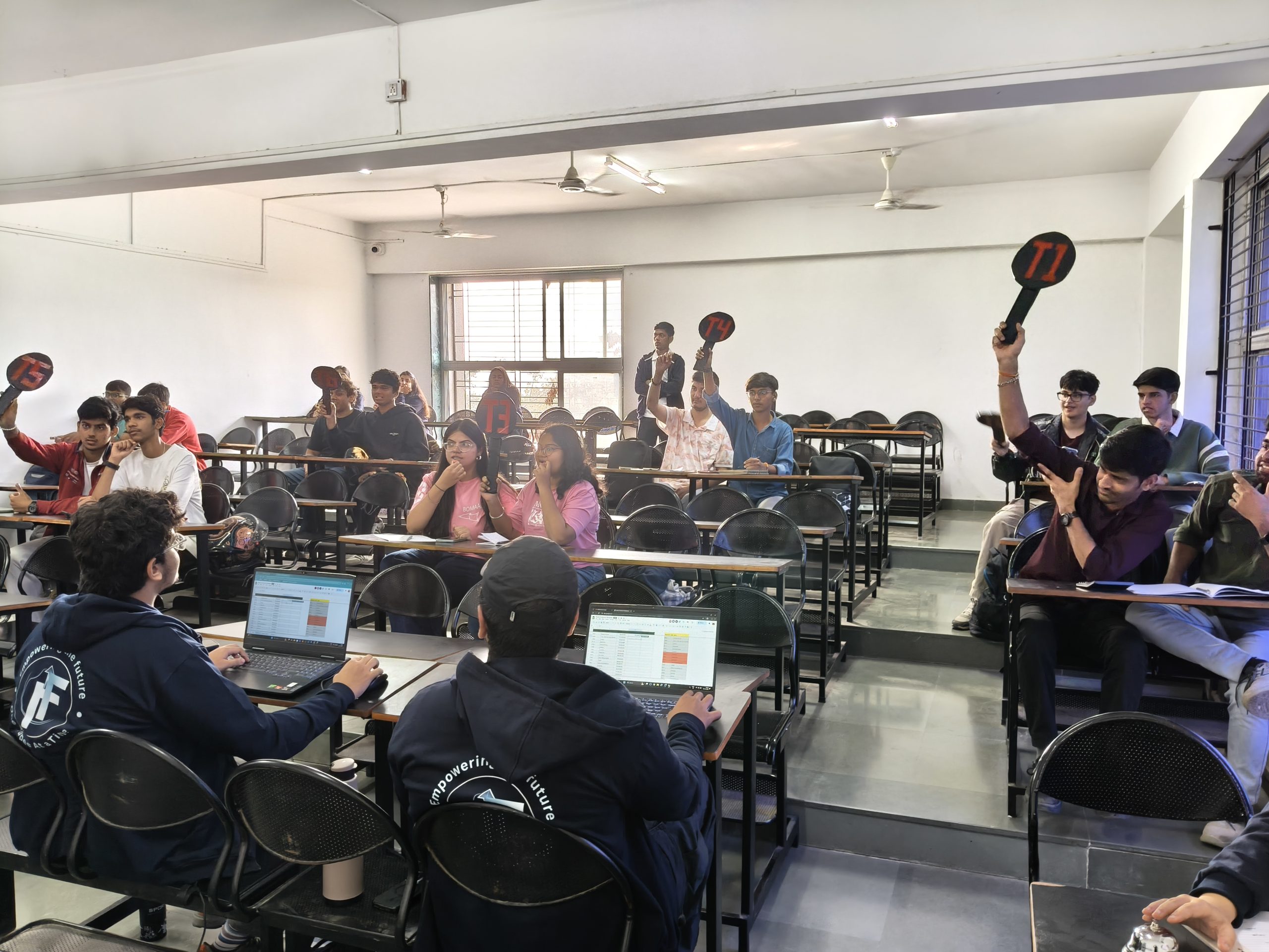 Participants negotiating and analysing property board during Investors Island simulation at BMCC